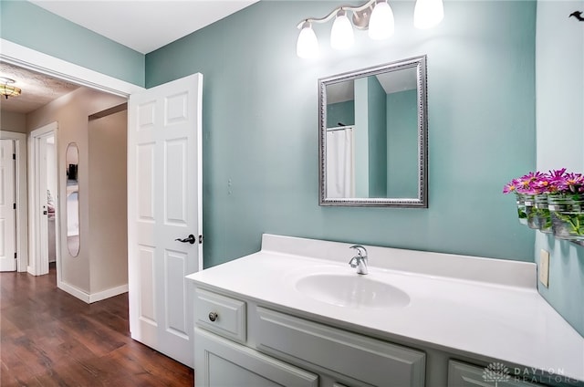 bathroom with vanity and hardwood / wood-style flooring