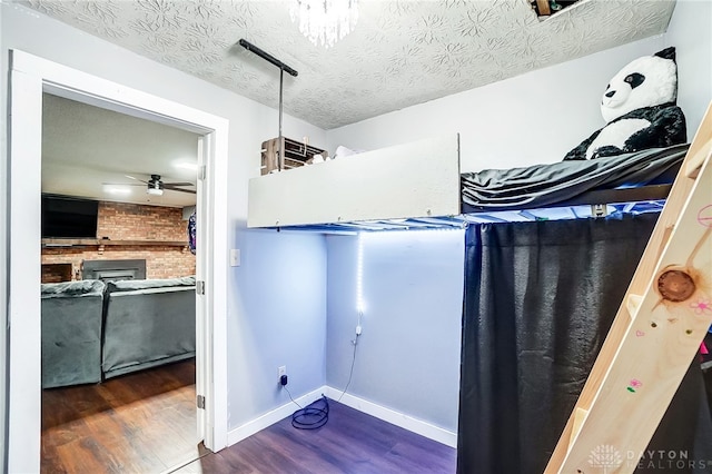 bathroom featuring hardwood / wood-style floors, a textured ceiling, and ceiling fan