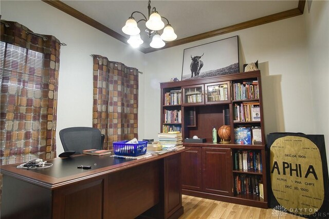 office space featuring light wood-type flooring, an inviting chandelier, and crown molding