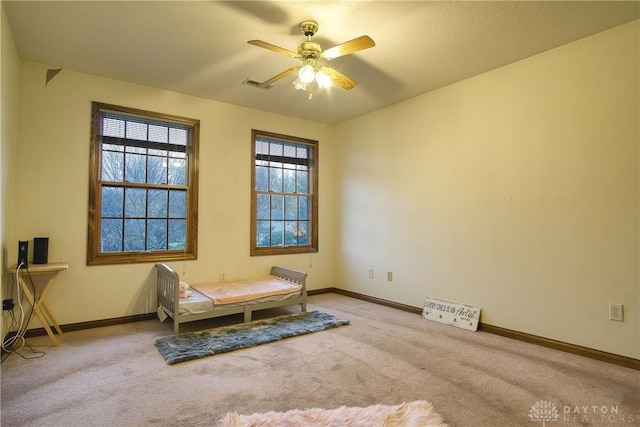 living area featuring ceiling fan and light carpet