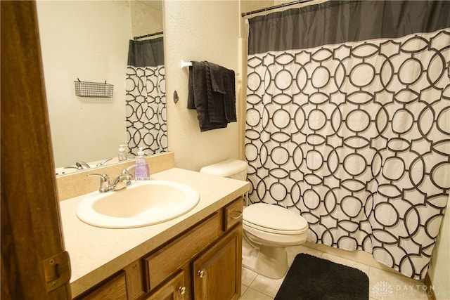 bathroom featuring vanity, tile patterned floors, and toilet