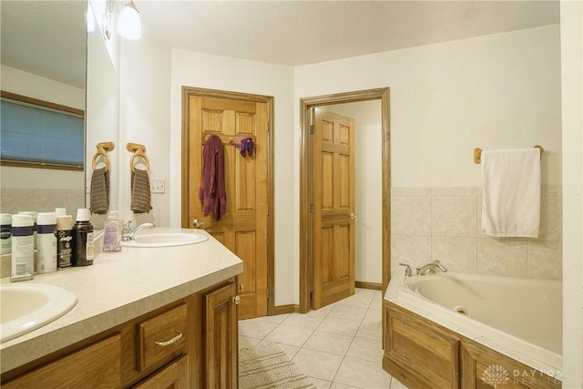 bathroom featuring a bath, tile patterned floors, and vanity