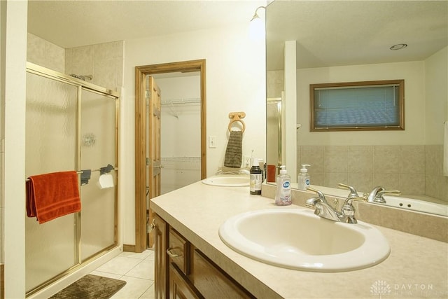 bathroom with vanity, an enclosed shower, and tile patterned floors