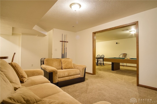 carpeted living room with pool table and a textured ceiling