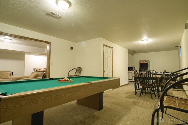 rec room with a textured ceiling, light colored carpet, and billiards