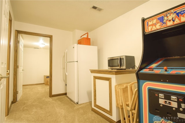 interior space featuring white refrigerator and light colored carpet