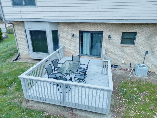 wooden terrace with central AC unit and a yard