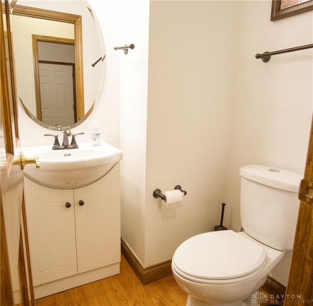 bathroom featuring hardwood / wood-style floors, vanity, and toilet