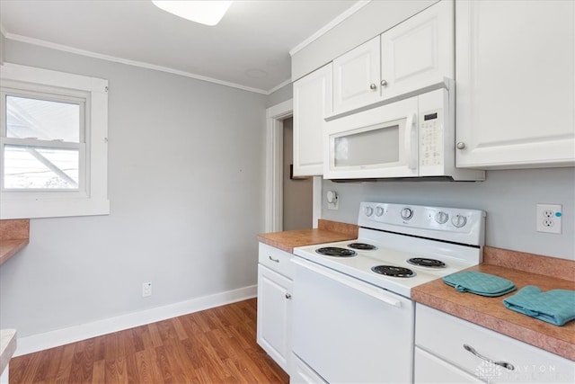 kitchen with white appliances, ornamental molding, light wood-type flooring, and white cabinets