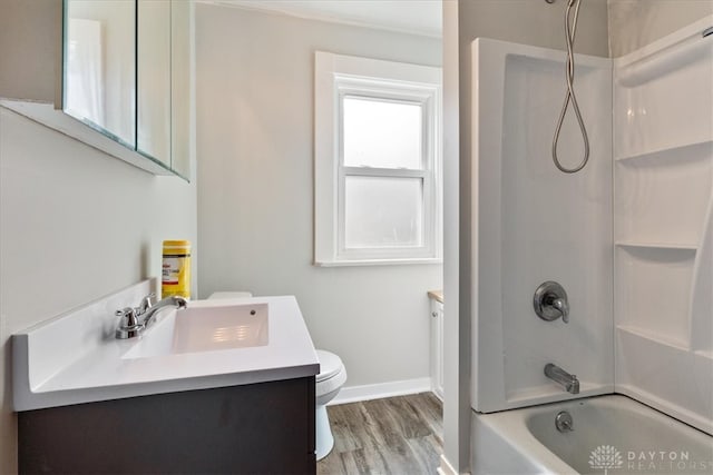 full bathroom featuring vanity, hardwood / wood-style floors, bathing tub / shower combination, and toilet