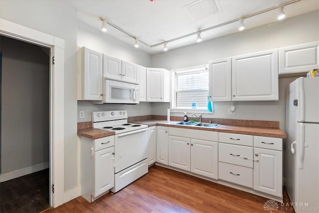 kitchen featuring light hardwood / wood-style flooring, white cabinets, sink, and white appliances