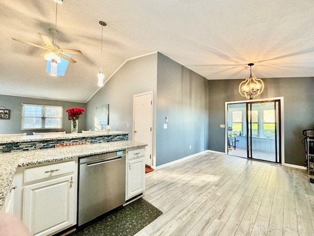 kitchen featuring dishwasher, white cabinetry, decorative light fixtures, and plenty of natural light