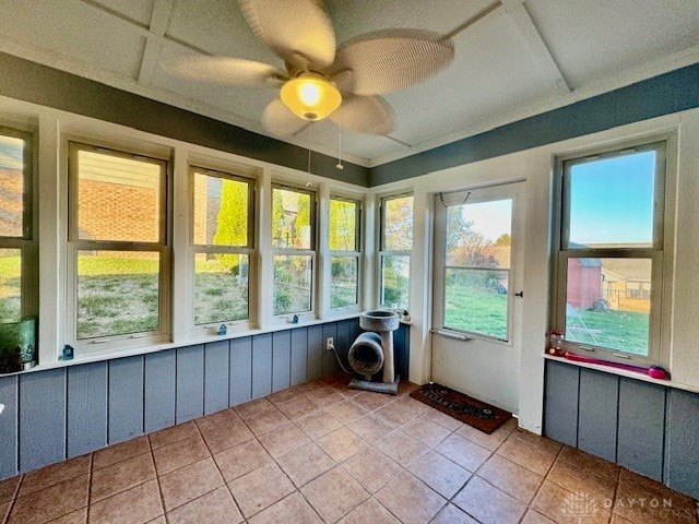 unfurnished sunroom with ceiling fan and a wealth of natural light