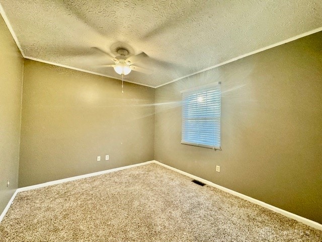 carpeted spare room featuring ornamental molding, a textured ceiling, and ceiling fan