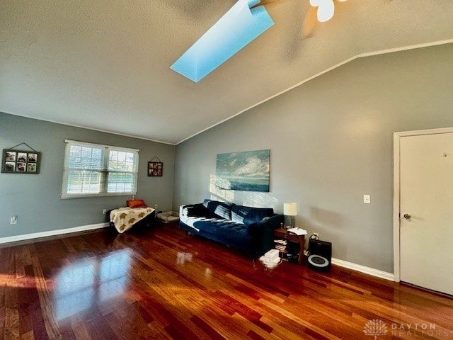 sitting room featuring lofted ceiling with skylight, a textured ceiling, and hardwood / wood-style flooring