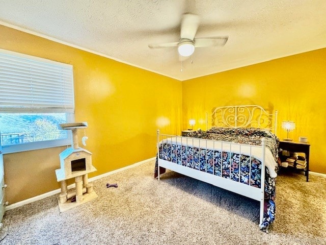 carpeted bedroom with ceiling fan and a textured ceiling