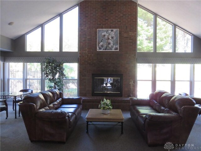 living room with expansive windows, carpet, high vaulted ceiling, and a brick fireplace