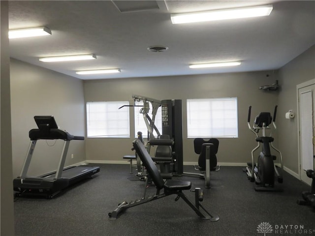 gym with visible vents and baseboards