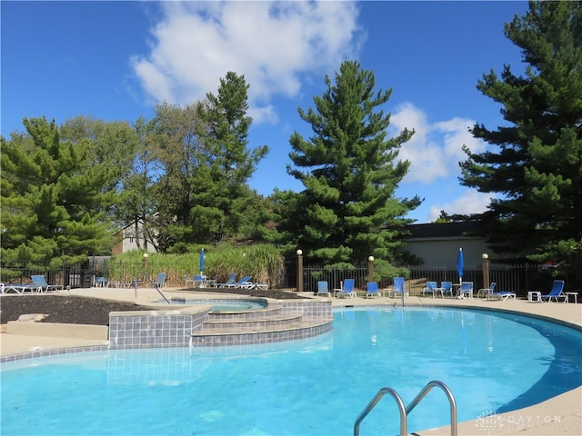 view of pool with a jacuzzi