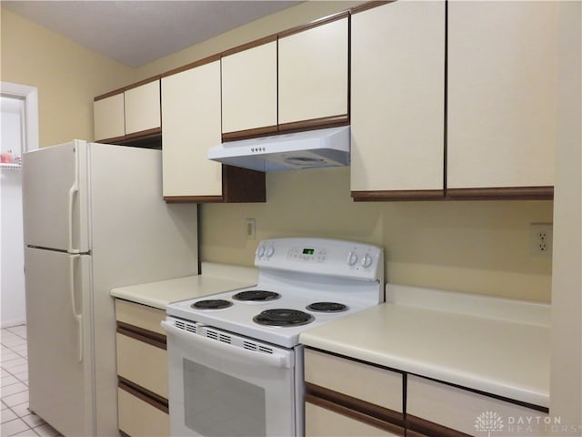 kitchen featuring white appliances, white cabinetry, and light tile patterned flooring