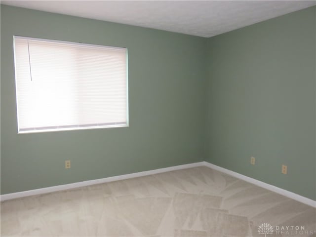 carpeted spare room with a textured ceiling