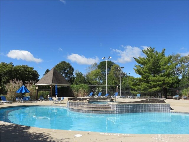 view of pool featuring a hot tub