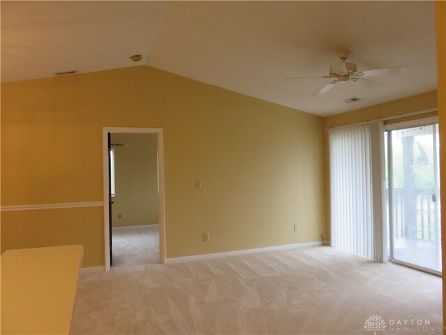 carpeted spare room with ceiling fan and lofted ceiling