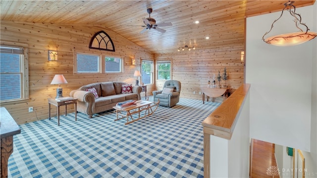 living room featuring wooden walls, wood ceiling, high vaulted ceiling, and ceiling fan