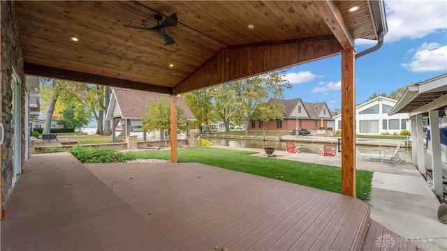 view of patio / terrace with a deck with water view and ceiling fan