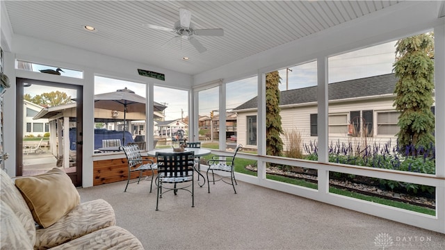 sunroom featuring ceiling fan, wooden ceiling, and plenty of natural light