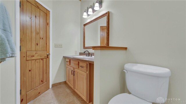 bathroom featuring vanity, toilet, and tile patterned flooring