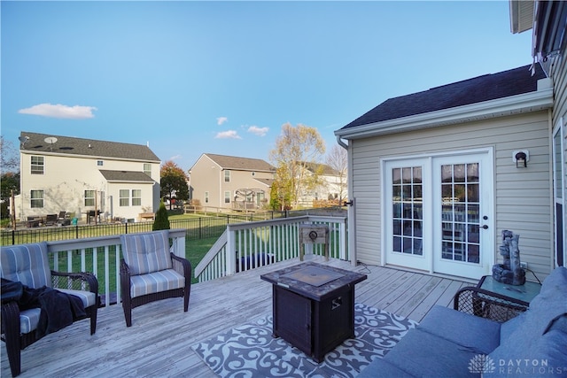 wooden terrace featuring a yard and an outdoor fire pit