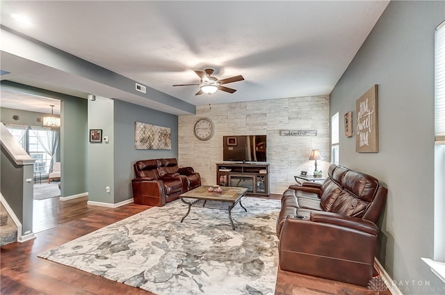 living room featuring ceiling fan and dark hardwood / wood-style flooring