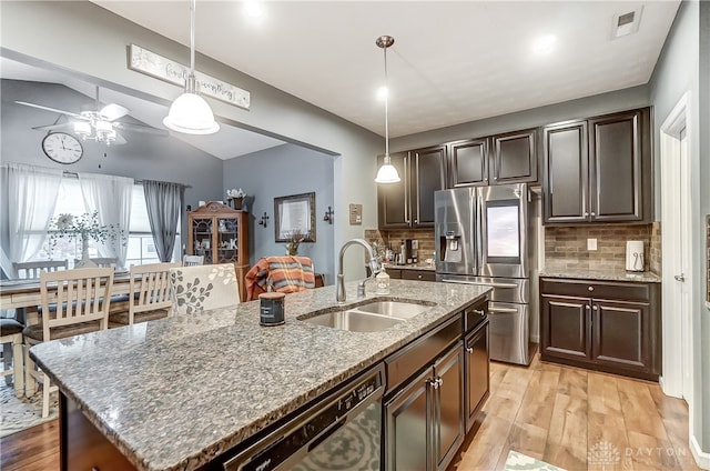 kitchen with pendant lighting, sink, an island with sink, and appliances with stainless steel finishes