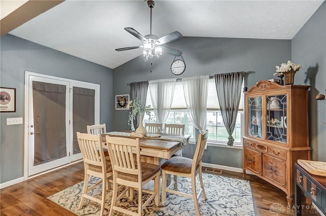 dining area with dark hardwood / wood-style floors, ceiling fan, and lofted ceiling