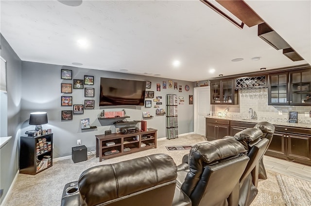 living room featuring light colored carpet and indoor wet bar