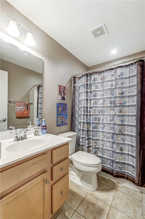 bathroom with tile patterned floors, vanity, and toilet