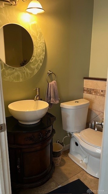 bathroom featuring tile patterned floors, vanity, and toilet