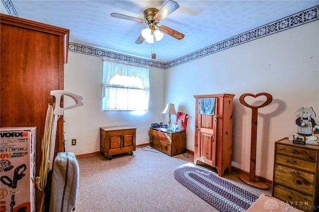 interior space featuring light colored carpet and ceiling fan