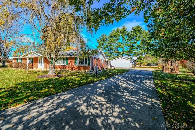 ranch-style home with a front lawn and a garage