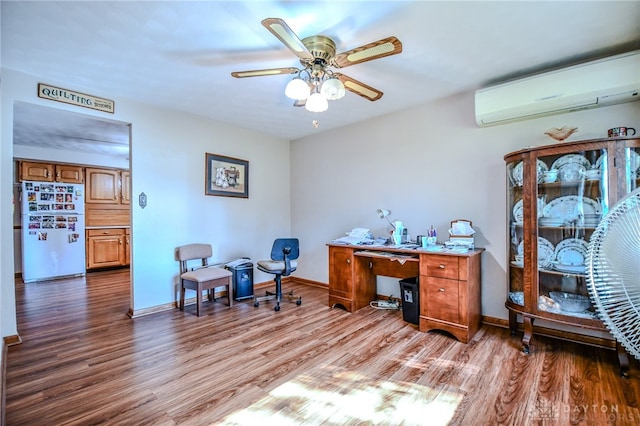 office area featuring a wall mounted air conditioner, hardwood / wood-style floors, and ceiling fan