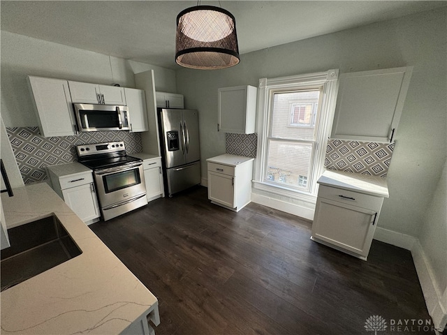 kitchen featuring white cabinetry, stainless steel appliances, and dark hardwood / wood-style flooring