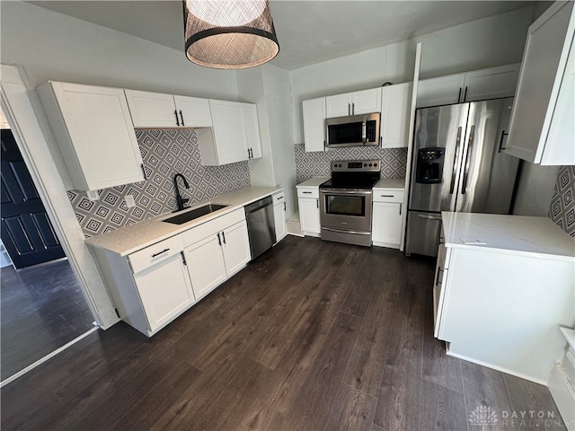 kitchen with dark wood-type flooring, white cabinetry, and stainless steel appliances