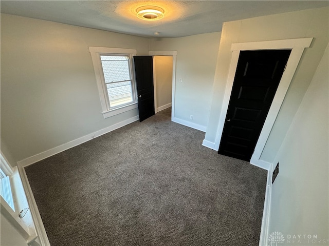 unfurnished room featuring carpet flooring