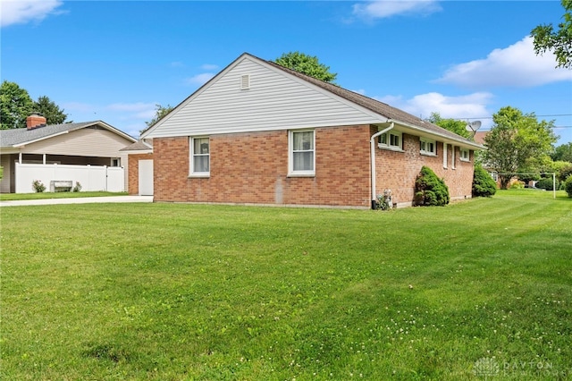 view of side of home featuring a yard