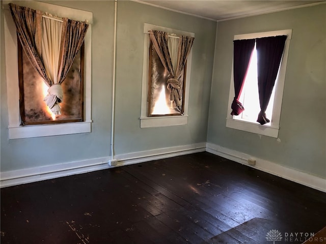 spare room with dark hardwood / wood-style floors and ornamental molding