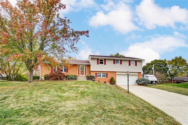 split level home with a garage and a front lawn