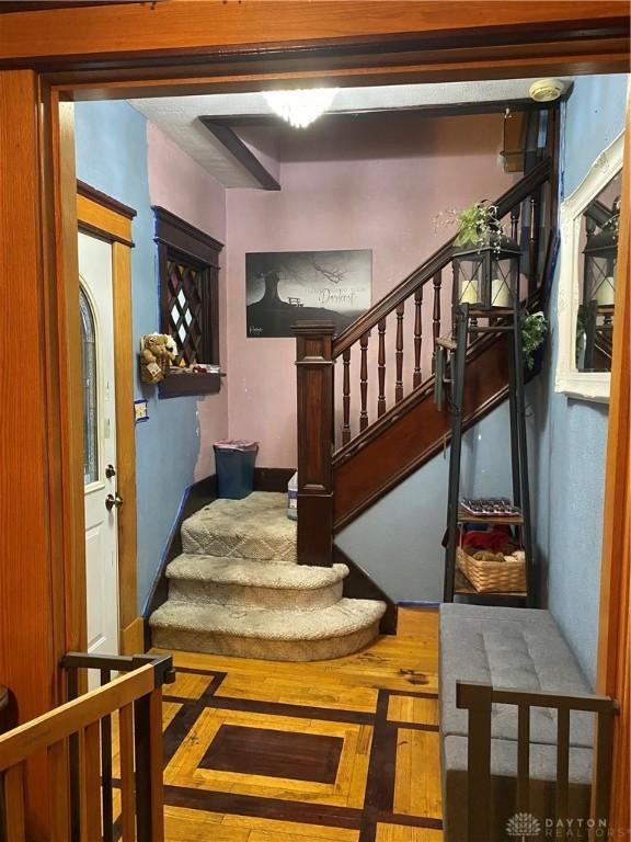 stairway featuring wood-type flooring