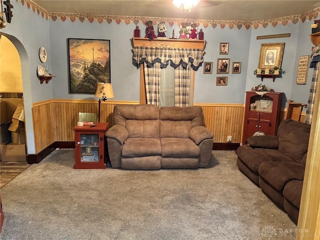 living room with wooden walls and carpet