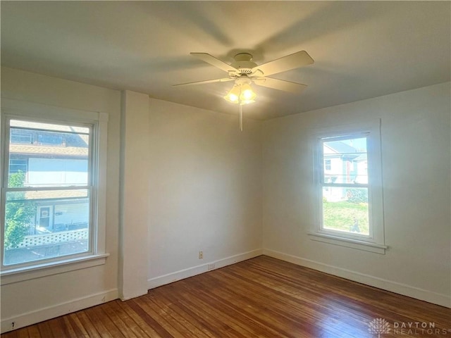 spare room with hardwood / wood-style flooring and ceiling fan